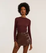 Blusa de punto de viscosa color bordó, con cuello asimétrico ceñido al cuello, mangas largas y fruncido lateral.