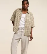 Pantalón baggy jeans color negro, con cierre de botón y cremallera, y bolsillos. Confeccionado en tejido de jean 100% algodón.