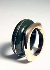 Pack de dos pulseras rígidas, una de resina verde oscura y otra metálica dorada de diseño cuadrado.
