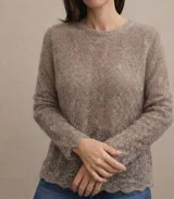 Sweater de punto calado confeccionado en 100% mohair italiano, con cuello redondo y mangas largas. Presenta una textura aireada y delicada con un diseño etéreo y sofisticado.