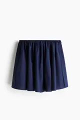 Minifalda circular azul marino de tejido liviano de algodón, con cintura elastizada y tiras decorativas a ambos lados.
