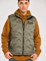 Chaleco acolchado color verde militar de la marca Caterpillar, con cierre frontal, bolsillos con ribete y parche con el logo de la marca en el pecho.