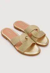 Sandalias planas Zingara de color dorado, con capellada de tiras cruzadas en tejido trenzado y plantilla metalizada.