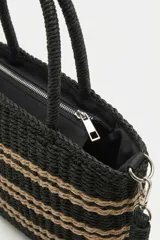 Bolso tipo tote negro tejido con rayas horizontales en color tostado, asas de mano rígidas y diseño estructurado.