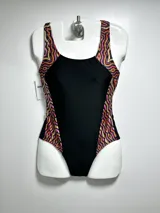 Malla entera de natación negra con paneles laterales estampados con motivos geométricos en tonos naranja, rosa y amarillo.