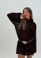 Remerón tipo vestido marrón de tejido de red con mangas largas y cinturón de cuero marrón con hebilla dorada.