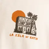 Remera blanca de algodón con cuello redondo y manga corta. Estampado en el pecho con una casa, un sol y palmeras.