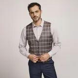Chaleco reversible Due Volti de corte sastrero, con diseño a cuadros en tonos de gris y cierre frontal con cuatro botones oscuros.