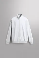 Sudadera relaxed fit gris claro melange de tejido ligero con mezcla de algodón, cuello subido, manga larga y cierre frontal con cremallera. Cuenta con bolsillos laterales ocultos y acabados en rib.