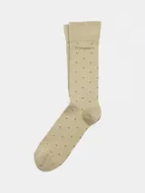 Medias color beige con lunares marrones y logo de la marca en el puño.