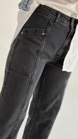 Pantalón de jean recto de tiro medio color gris oscuro con costuras verticales.