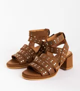 Sandalias de cuero color bordó con tres tiras horizontales sobre el empeine y pulsera al tobillo, ambas con apliques de tachas plateadas.