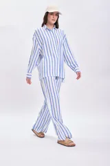 Pantalón casual de corte amplio con estampado de rayas verticales celestes y blancas, con cintura elastizada y cordón ajustable.