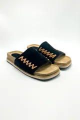 Sandalias bajas color marrón, con base de corcho y tira ancha de gamuza con pespuntes decorativos en hilo dorado.