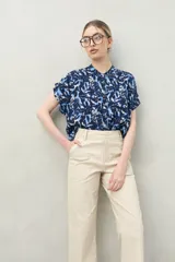 Pantalón negro de algodón con calce recto y relajado, tiro medio/alto, bolsillos de parche en la parte delantera y puños anchos.