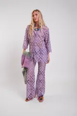 Pantalon de tela calada encaje de guipur color lila, de corte recto con terminación evasé y cintura elástica.