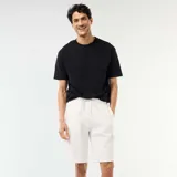 Bermuda de piqué de algodón color blanco, con múltiples bolsillos tipo cargo y cordón ajustable en la cintura.