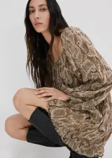 Vestido corto de viscosa con estampado de serpiente, cuello cuadrado y manga larga con puños elásticos. Presenta cintura con goma elástica y forro interior de poliéster.