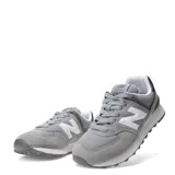 Championes urbanos New Balance modelo 574, color gris con detalles en blanco y negro. Confeccionados en una combinación de gamuza y malla, presentan el logo 'N' característico en los laterales y entresuela con tecnología ENCAP para mayor amortiguación.