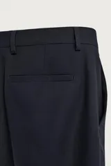 Pantalón de traje straight fit color azul marino, confeccionado en tejido con lana, con bolsillos frontales, bolsillos traseros de vivo y cierre frontal con cremallera y botón.
