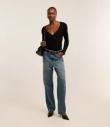 Blusa negra de punto acanalado, con escote en V profundo y mangas largas.