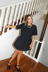 Vestido corto color verde oliva, de manga corta y corte holgado con frunce en la cintura que genera un efecto de falda globo (balloon).