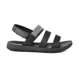 Sandalias bajas negras con tiras horizontales, una de ellas con detalle de tejido brillante.
