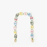 Correa corta para cartera Clare V con eslabones de porcelana estampados con motivos florales.