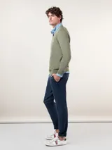 Pantalón chino azul marino de corte slim fit, confeccionado en gabardina con 77% algodón, 20% de algodón reciclado y 3% elastano. Presenta bolsillos delanteros y traseros. Tiene un lavado final con enzima ácida que le da un aspecto desgastado.