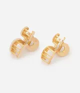 Kit de dos pinzas para el pelo con diseño orgánico y curvo. Una pieza presenta acabado metálico dorado y la otra un diseño marmolado en tonos claros con detalles dorados, ambas con mecanismo de resorte metálico interno y dientes intercalados.
