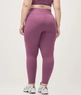 Pantalón deportivo legging de microfibra color violeta, con cintura alta elástica y bolsillos laterales.