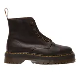 Botas de plataforma Dr. Martens modelo Sinclair, confeccionadas en cuero Crazy Horse color marrón oscuro con acabado desgastado. Presentan suela de goma estriada con costuras amarillas características, cierre frontal con cordones y cremallera central removible.