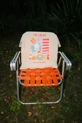 Remera oversize color beige con estampa frontal colorida con motivos de verano, incluyendo texto 'TA'CALOR' y 'PICA X PETRICHOR'.