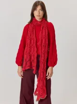 Buzo de lana color rojo, con diseño de tejido calado y mangas abullonadas. Presenta un corte clásico con puños y cuello ajustados.