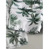 Conjunto de traje de baño de tres piezas con estampado de hojas tropicales en tonos blanco y negro. Incluye un top tipo tankini con cordón ajustable en el centro, un short de tiro alto y una camisa abierta de manga larga tipo salida de baño.