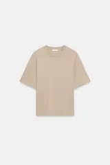 Camiseta de algodón color beige con efecto lavado, cuello redondo y mangas cortas de corte regular fit.