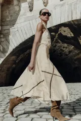 Vestido midi de cuello halter con diseño de cuadros, cintura elástica y abertura en la espalda. Cuenta con cierre de cremallera oculta y botón en la parte posterior.