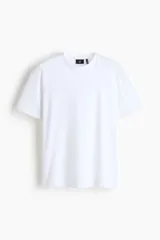 Remera blanca de manga corta, confeccionada en punto liviano con cuello redondo ribeteado y bajo recto, de corte estándar y silueta clásica.