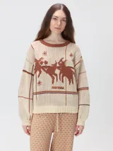 Sweater de punto con diseño geométrico y gráfico frontal en color rojo. Presenta cuello redondo, mangas largas holgadas y un ajuste suelto.