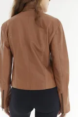 Campera corta de cuero color tostado con cuello alto, cierre frontal y bolsillos laterales con cierre. Presenta costuras pespunteadas en contraste y calce entallado.
