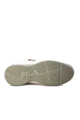Championes deportivos Fila modelo Lugano 7.0, color blanco con detalles en azul marino y rojo, diseño con malla transpirable y suela de goma gris.