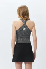 Top sin mangas de cuello halter cruzado, de morley color gris, ajustado al cuerpo y con textura acanalada.