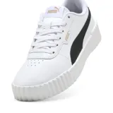 Championes Puma Carina 3.0 de cuero blanco con detalles en negro, suela de plataforma y logo dorado.