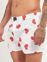 Bóxer de algodón blanco con estampado de flores pequeñas color celeste, con cintura elástica y logo de la marca en el centro.