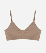 Soutien tipo bralette confeccionado en poliamida seamless, con escote en V, breteles finos ajustables y copas desmontables. Presenta un diseño liso con detalle fruncido en el centro del busto.