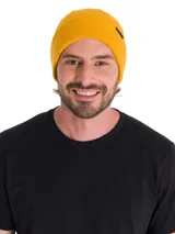 Gorro de lana estilo beanie color amarillo, con tejido de punto acanalado, puño enrollado y pequeña etiqueta negra con el logo de la marca en el lateral.