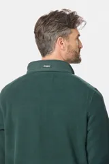 Buzo de micro polar con interior térmico, cuello alto y cierre frontal parcial. Presenta paneles de taslón al tono en el frente y cuello, con bolsillos laterales con cierre y detalle de logo en la manga.