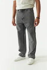 Jean estilo carpenter de corte relajado, recto y amplio, con diseño de cinco bolsillos y costuras reforzadas características del modelo. Presenta un acabado lavado en tono gris oscuro.