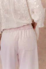 Pantalón de denim liviano color beige, de calce amplio y relajado con pierna recta. Cuenta con cintura elastizada, cordón regulable, bolsillos laterales y costuras delanteras verticales que estilizan la silueta.