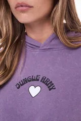 Buzo tipo canguro de felpa con capucha, color violeta con efecto lavado. Presenta un estampado frontal con la frase 'Jungle Army' y un corazón blanco, además de un bolsillo tipo canguro delantero.